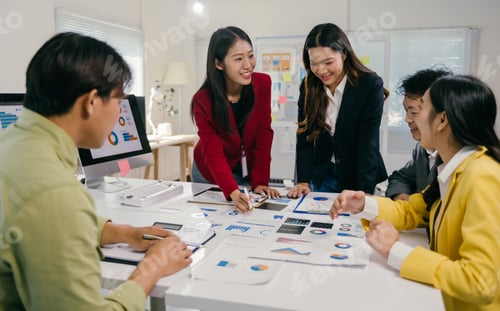 Preview: Asian business team analyzing charts and reports in office meeting