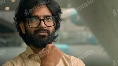 Preview: Thoughtful Arabian businessman looking away thinking of future business challenges. Doubtful serious