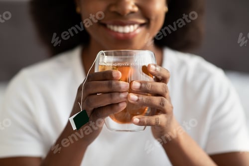 Preview: Female hands holding mug with hot drink, cropped