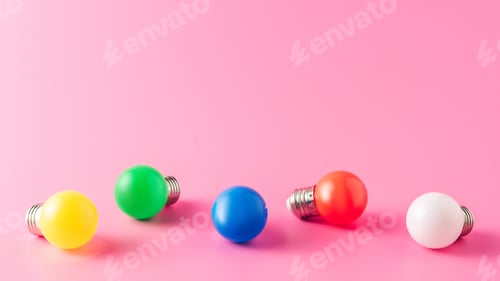 Preview: close-up view of bright colorful light bulbs on pink