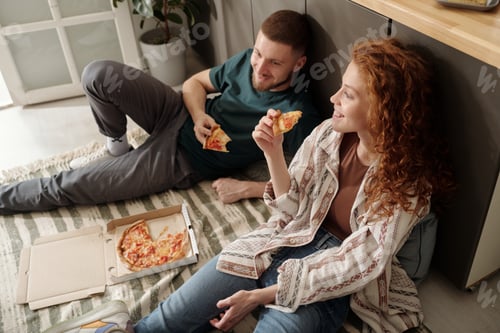 Preview: Young couple enjoying lunch on the floor