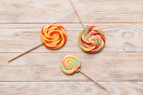 Preview: Set of colorful lollipops on colored background. Summer concept.