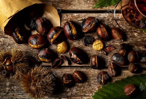 Preview: Roasted Chestnuts on rustic wooden table.