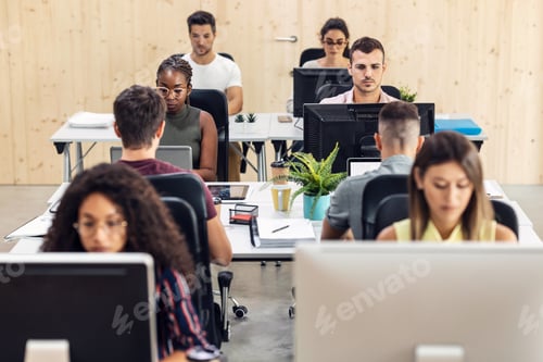 Preview: Multiethnic businesspeople working with computers in a coworking place.