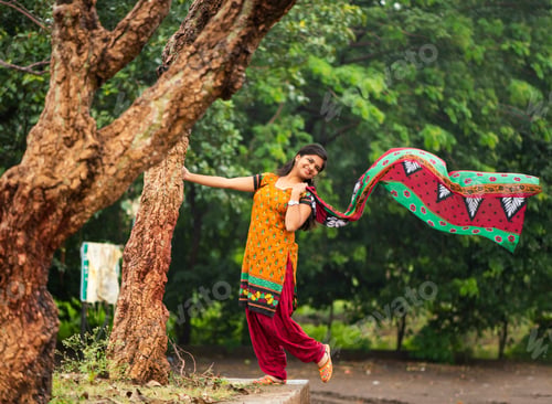 Preview: Young girl near tree trunk and she enjoying fresh air outdoors