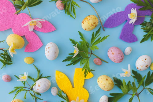 Preview: Happy Easter! Colorful Easter bunnies, chocolate eggs and spring flowers composition flat lay