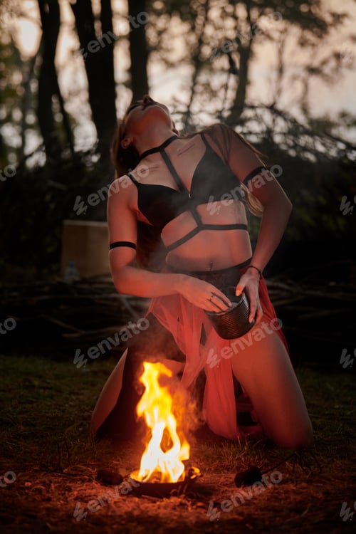 Preview: Girl fire dancing performance at outdoor art festival, smooth blurred movements of female