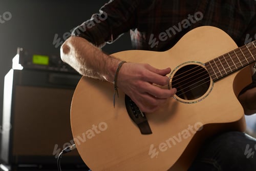Preview: Close Up Of Man Playing Amplified Acoustic Guitar