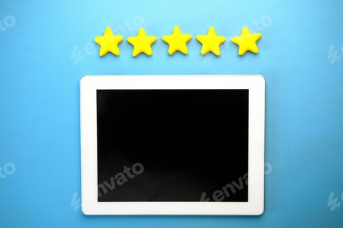 Preview: Customer review concept. Rating golden stars and digital tablet on blue