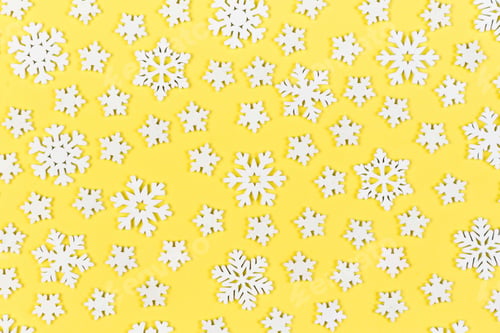 Preview: Top view of white snowflakes on colorful background. Winter weather concept with copy space