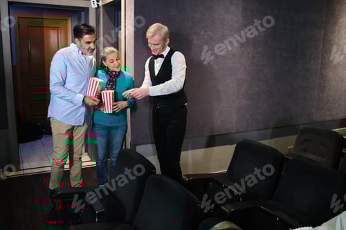 Preview: Usher checking tickets of couple entering movie theater