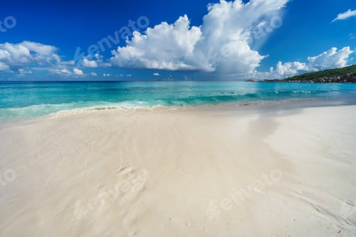 Preview: Summer vacation holiday. White clouds above blue ocean lagoon, calm waves on tropical beach
