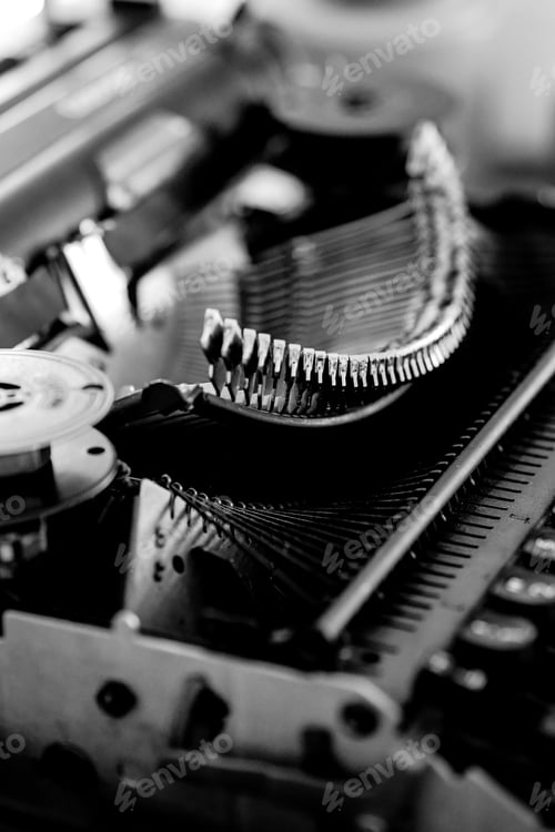 Preview: Grayscale closeup shot of an old vintage typewriter with blurred background