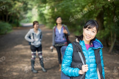 Preview: Three young female hikers on country road