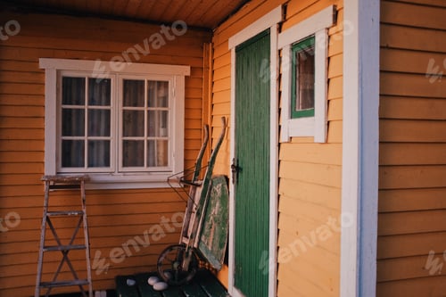 Preview: yellow wooden cabin in a sunset light