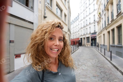 Preview: Close up happy woman taking selfie by city street