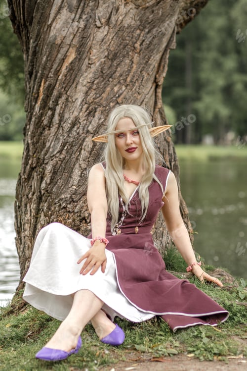 Preview: Young elf girl with blond long hair. Beautiful medieval elven princess in a burgundy dress