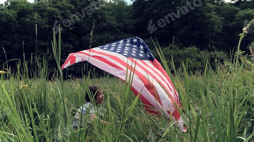Preview: Patriotic holiday.Young boy with American flag.USA celebrate 4th of July.