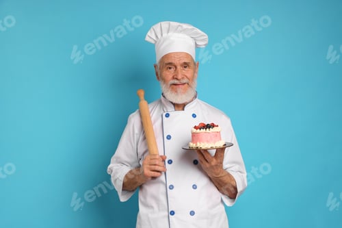 Preview: Professional pastry chef with delicious cake and rolling pink on light blue background