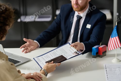 Preview: Close up of woman handing visa application