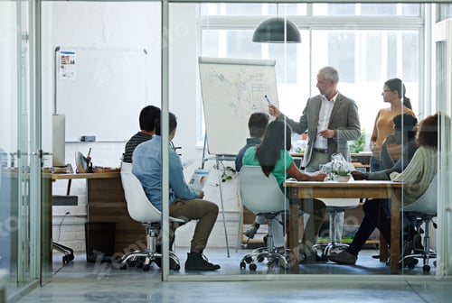 Preview: Passing on some sagely advice. Shot of a group of coworkers in a boardroom meeting.