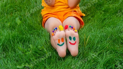 Preview: a smile painted with paints on the child's arms and legs.