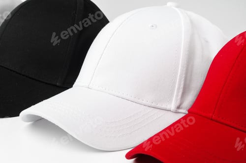 Preview: Lineup of Four Blank Baseball Caps in Red, White, and Black on a White Background