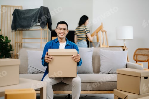 Preview: Young couple with big boxes moving into a new house, new apartment for couple,
