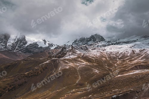 Preview: Powerful cloudscape over snow capped mountains