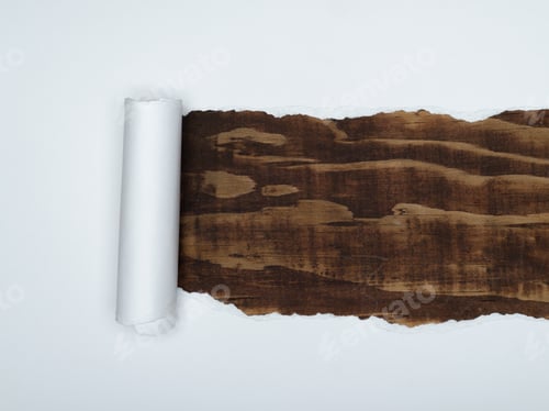 Preview: A piece of white paper is torn to reveal a dark brown wood grain underneath