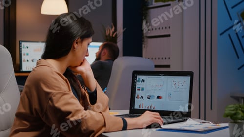 Preview: Tired workaholic executive businesswoman typing financial strategy on laptop computer