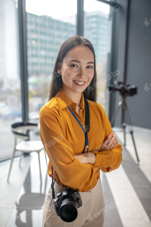 Preview: Dark-haired young cute reporter standing in the studio