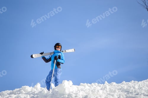 Preview: Woman skier on top of the mountain. Winter sports concept