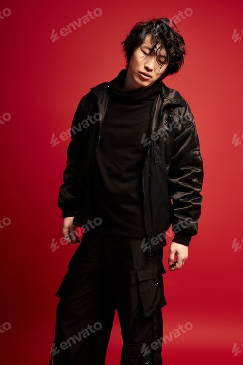 Preview: Dashing korean model strikes a confident pose in a studio setting with a bold backdrop