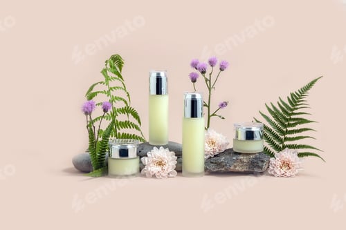 Preview: Bottles for cosmetics on a stone podium surrounded by fern leaves and chrysanthemum flowers