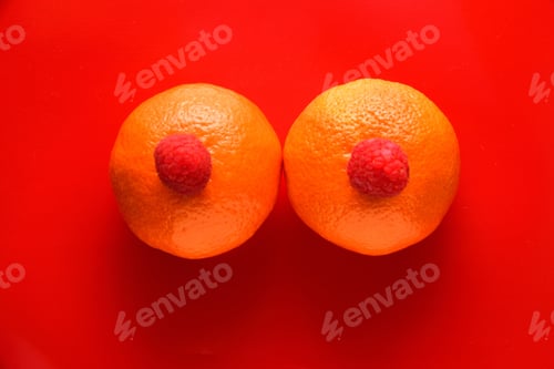 Preview: High angle shot of two tangerines with two raspberries on the top of them