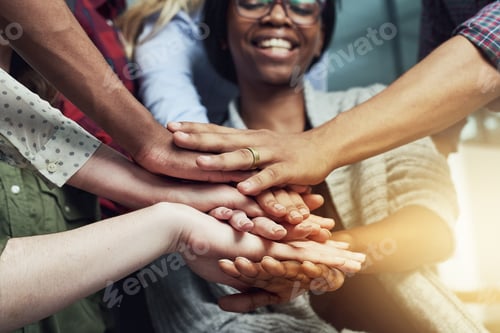 Preview: Positivity all around. Shot of a group of people putting their hands together.