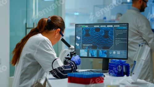 Preview: Biotechnology scientist researching in laboratory using microscope