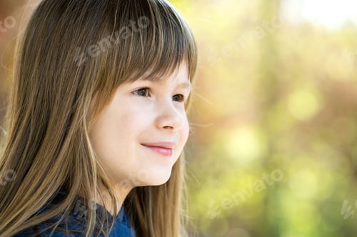 Preview: Portrait of pretty child girl with gray eyes and long fair hair smiling outdoors on blurred bright