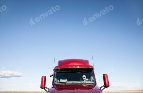 Preview: View of a Caucasian woman driver in the cab of her commercial truck.