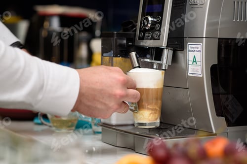 Preview: Man preparing Latte on Coffee machine