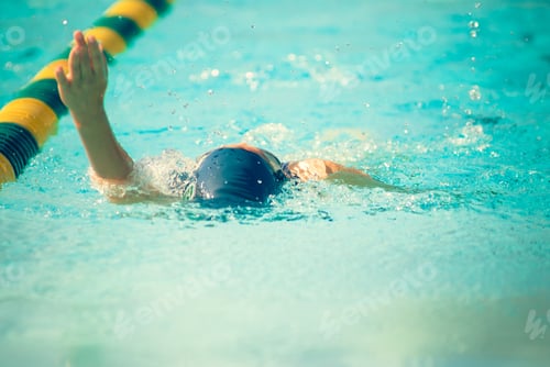 Preview: Adult Swimmer in Water near Yellow Lane Marker