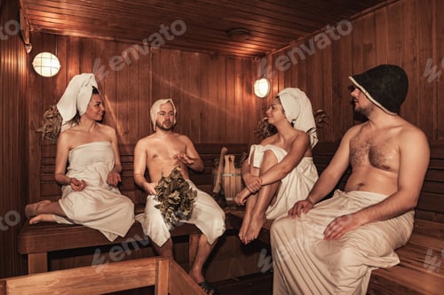 Preview: Russian bathhouse. Two couple relaxing and sweating in wooden sauna with hot steam. Four person with