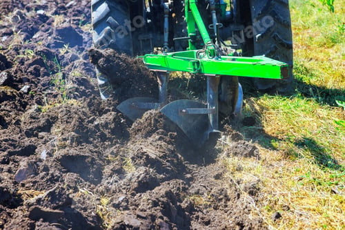 Preview: In spring, tractor plows are used to cultivate soil and prepare field for a sowing grain