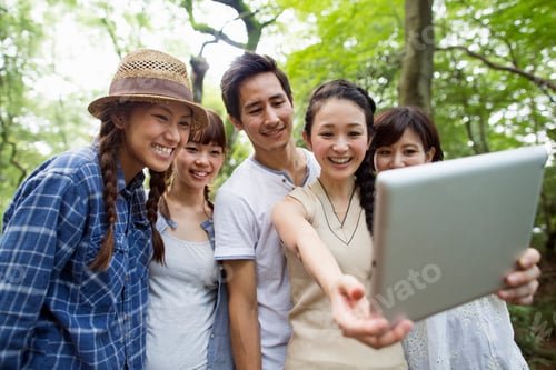 Preview: Group of friends at an outdoor party in a forest.