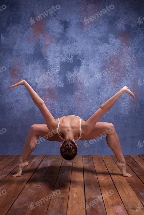 Preview: Young Beautiful Dancer In Beige Swimwear Dancing On Lilac Studio Background On Wooden Floor