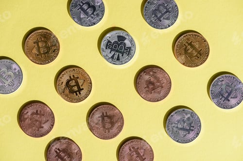 Preview: top view of arranged various bitcoins on yellow tabletop