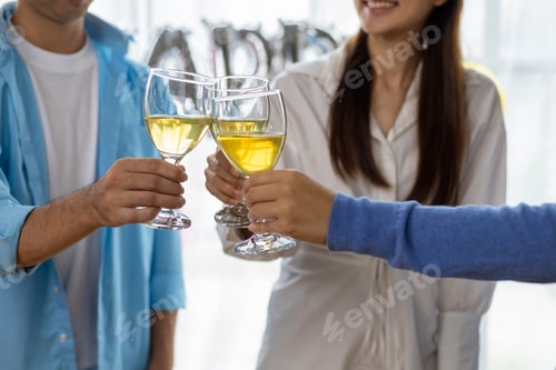 Visualização: Saúde, tilintar copos, amigos tomando uma bebida para comemorar em uma pequena festa em seu escritório doméstico.