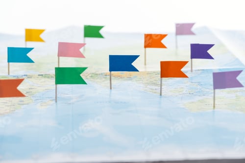 Preview: selective focus of colorful flags pinned on world map