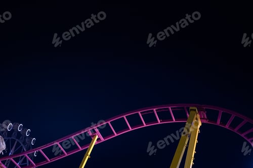 Preview: Rails of a roller coaster, blue night sky background.